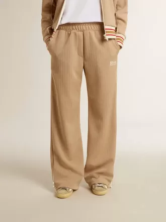 Lys beige joggingbukser til kvinder med hvidt logo