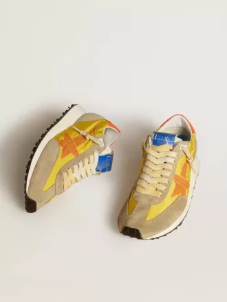 Marathon til kvinder med gul nylonoverdel og orange stjerne